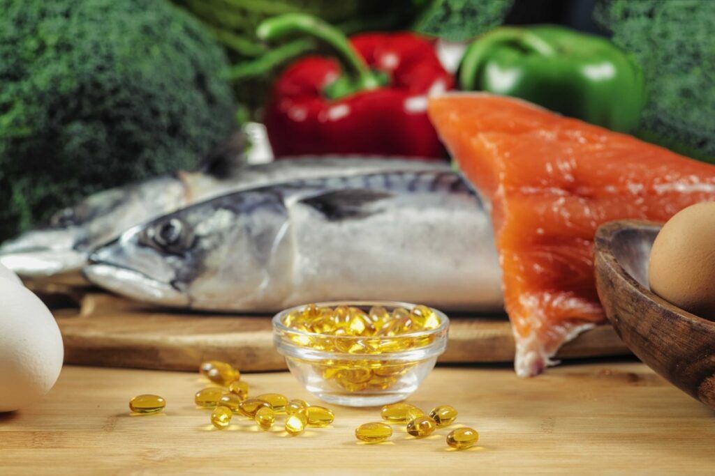 vitamin D capsules on salmon meat background
